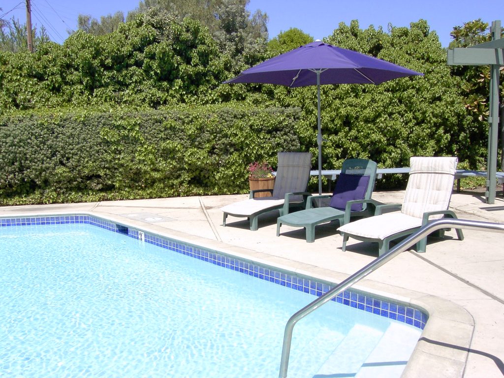 seating in pool area, shade under umbrella